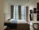 Modern apartment bedroom with large windows and contemporary furniture