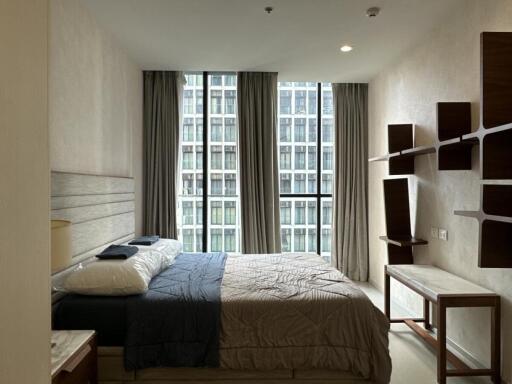 Modern apartment bedroom with large windows and contemporary furniture