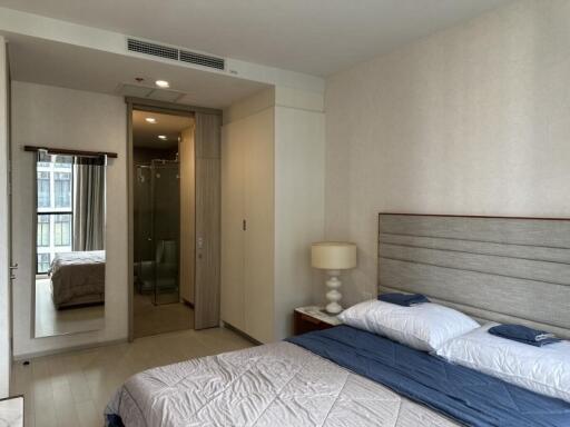 Modern and cozy bedroom with ensuite bathroom and full-length mirror