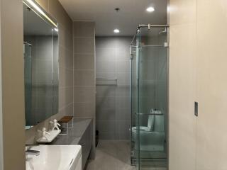 Modern bathroom with glass shower and large mirror