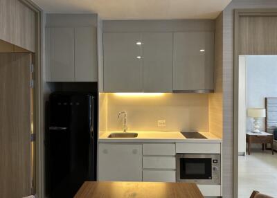 Modern kitchen with built-in appliances and wooden dining table