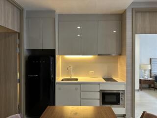 Modern kitchen with built-in appliances and wooden dining table