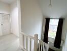 Bright hallway with window and staircase