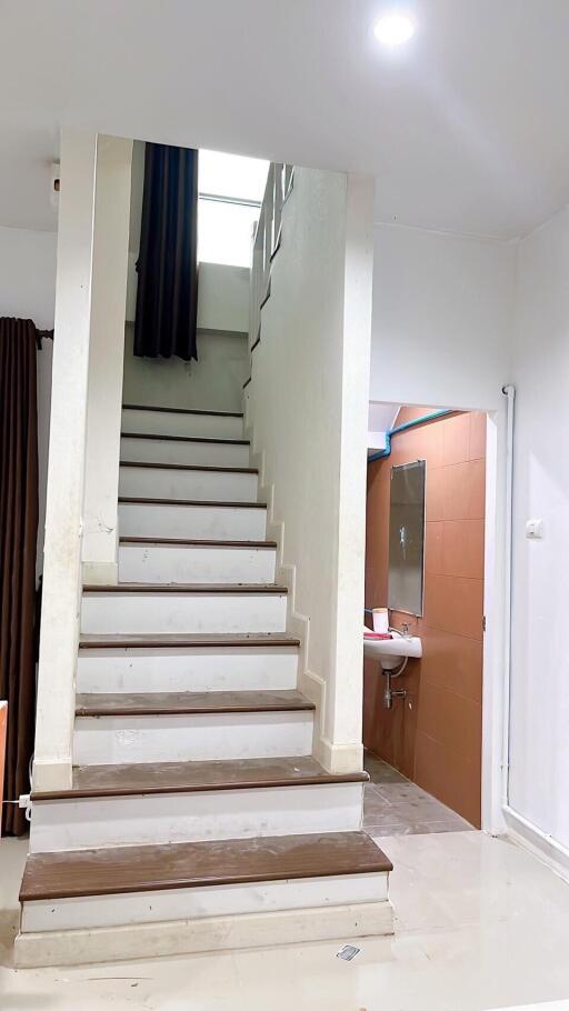 Indoor staircase with partial view of bathroom