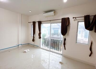 Empty living room with large sliding glass doors and windows