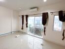 Empty living room with large sliding glass doors and windows