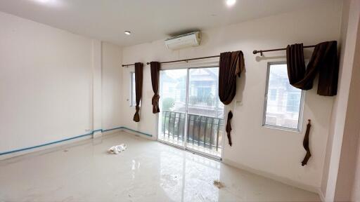 Empty living room with large sliding glass doors and windows