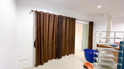 Room with brown curtains and various items