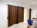 Room with brown curtains and various items