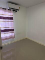 Empty bedroom with air conditioner and curtain