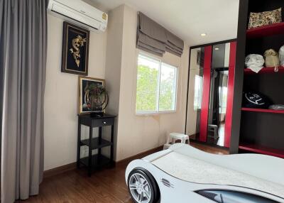 Bedroom with modern decor and unique car-shaped bed