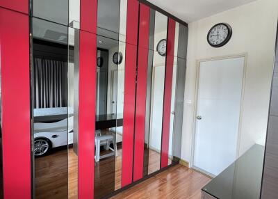 Modern bedroom with mirrored and red accent wardrobes