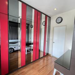 Modern bedroom with mirrored and red accent wardrobes