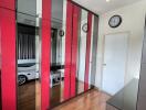 Modern bedroom with mirrored and red accent wardrobes