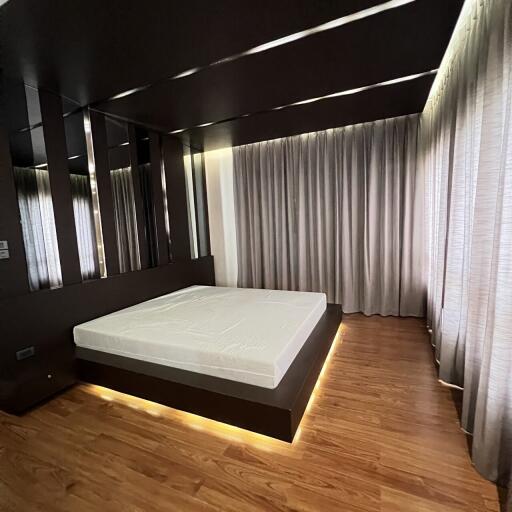 Modern bedroom with a platform bed and wooden flooring