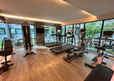 Gym with modern exercise equipment and large windows