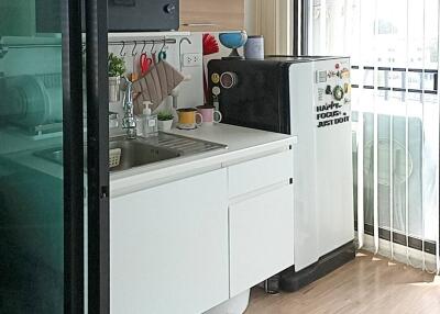 Modern small kitchen with appliances and natural light