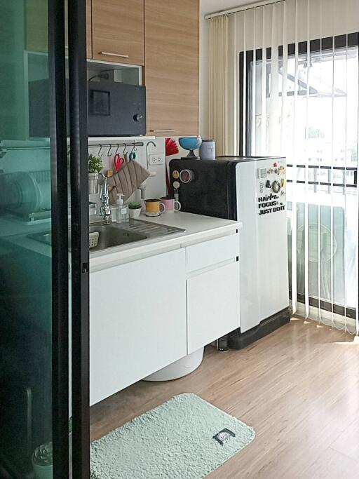 Modern small kitchen with appliances and natural light