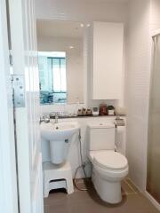 Modern bathroom with white fixtures and a large mirror