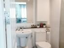 Modern bathroom with white fixtures and a large mirror