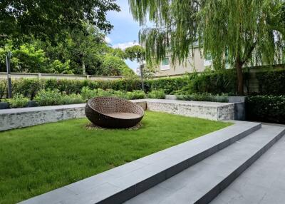 Well-maintained garden with modern outdoor seating and lush greenery