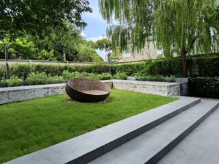 Well-maintained garden with modern outdoor seating and lush greenery