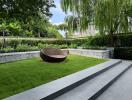 Well-maintained garden with modern outdoor seating and lush greenery