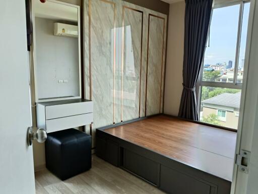 Bedroom with a raised platform bed and dresser with mirror