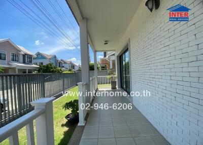 Front porch of a house with a view of the neighborhood