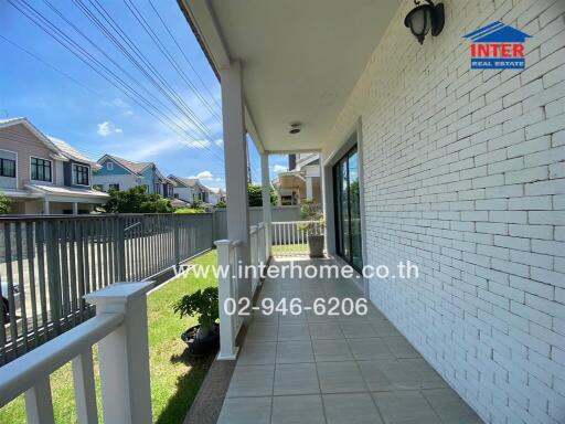 Front porch of a house with a view of the neighborhood