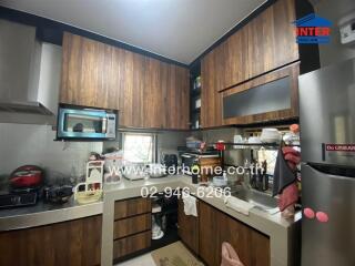 Modern kitchen with wooden cabinets and stainless steel appliances