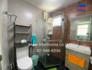 Modern bathroom with glass shower enclosure and wall-mounted sink.