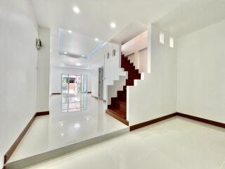 Spacious and modern main living area with staircase