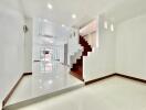 Spacious and modern main living area with staircase