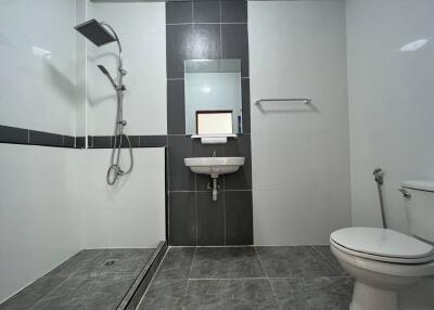 Modern bathroom with shower, sink, and toilet