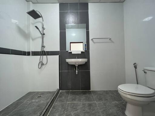 Modern bathroom with shower, sink, and toilet