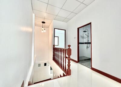 Bright hallway with stairway and bathroom access