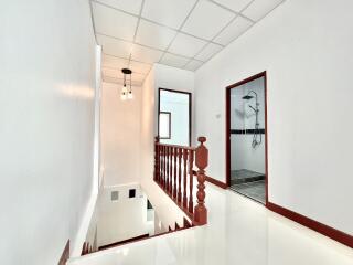 Bright hallway with stairway and bathroom access