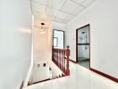 Bright hallway with stairway and bathroom access