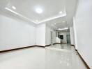 Spacious living room with bright white walls and tiled floors