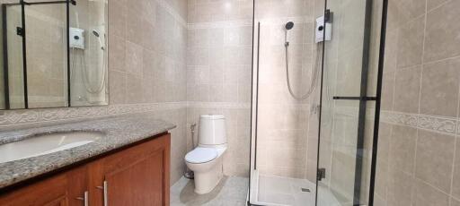 Modern bathroom with glass shower and granite countertop