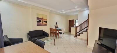 Modern living room with dining area and staircase