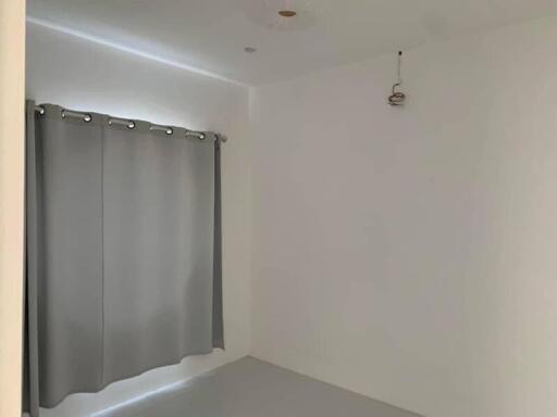 Empty room with grey curtains and white walls