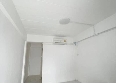 Simple white-walled room with air conditioning