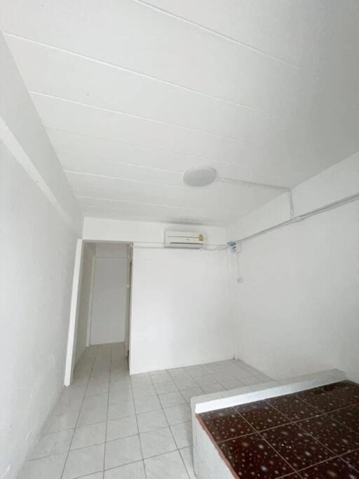 Simple white-walled room with air conditioning