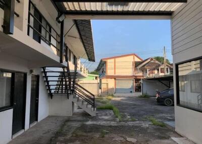 Exterior view of building complex with stairs and parking area