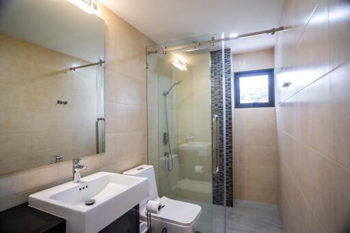 Modern bathroom with glass shower enclosure and large mirror