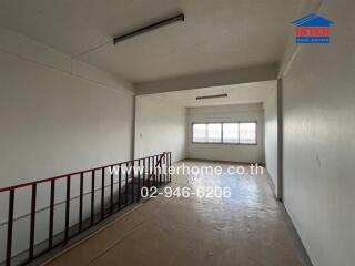 Interior space of a building with a staircase and large window