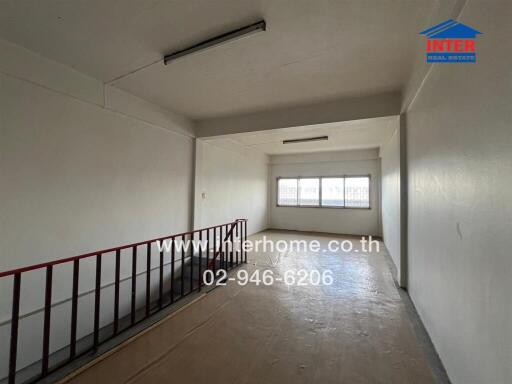 Interior space of a building with a staircase and large window