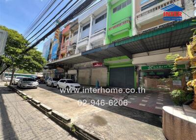 Street view of commercial buildings with shop fronts